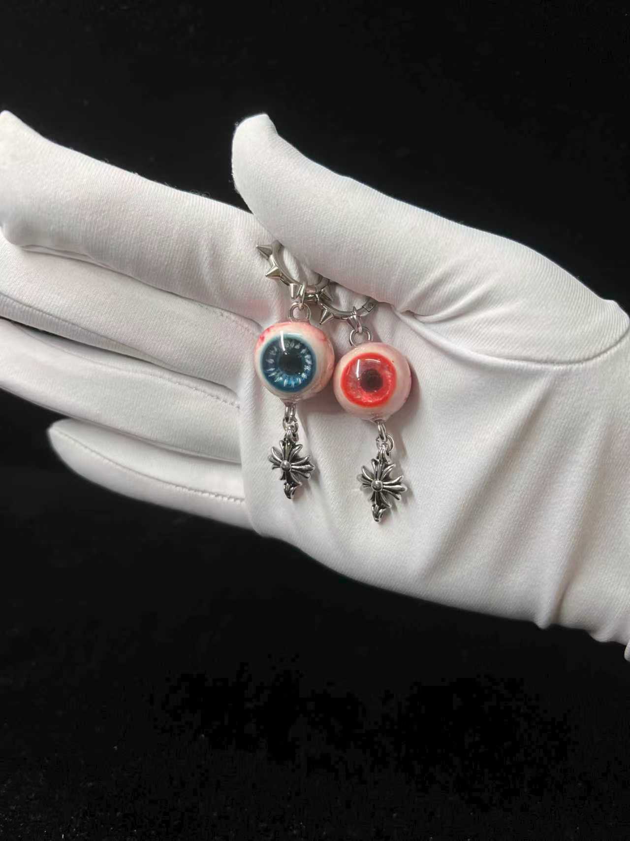 blue and red earrings with eyeball design pastel goth resin jewelry